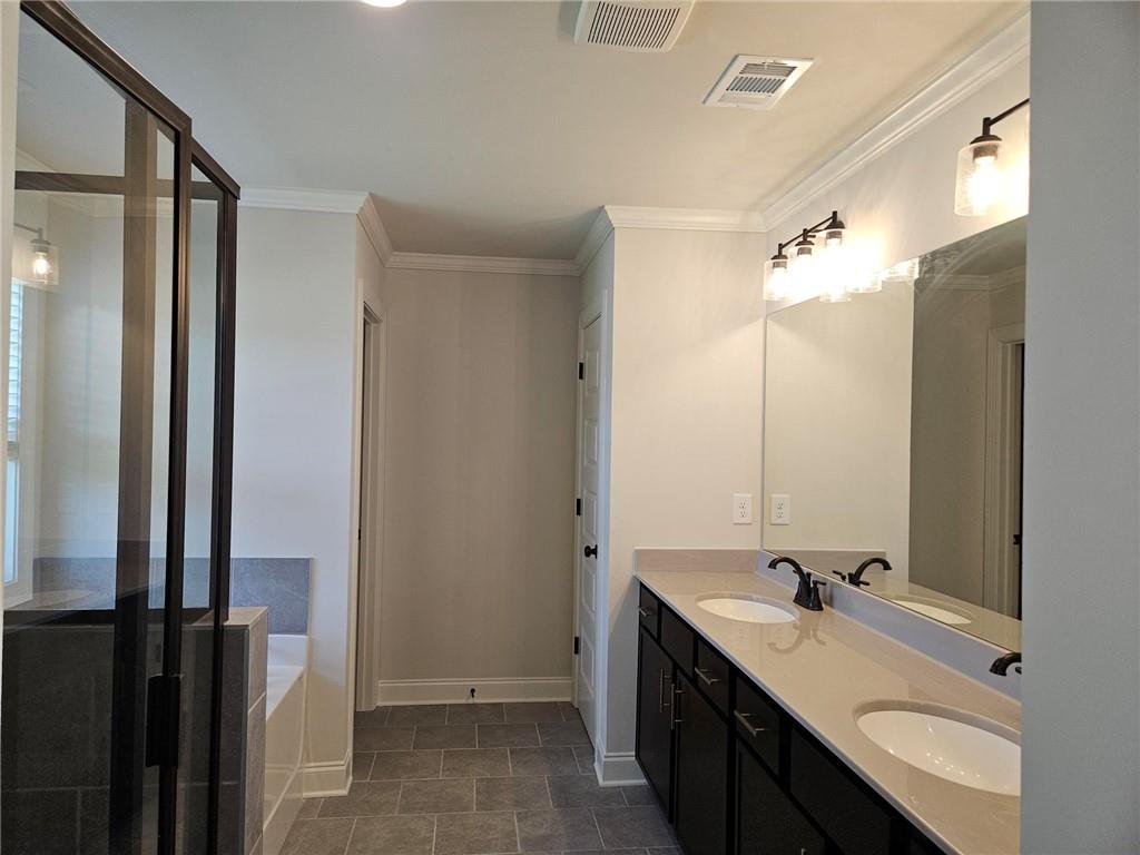 440 Banff Drive Winder, GA 30680 - Photo 18 of 18 a bathroom with a double vanity sink mirror and double