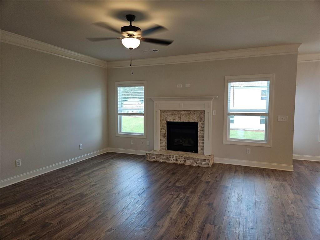 440 Banff Drive Winder, GA 30680 - Photo 8 of 18 a view of an empty room with wooden floor fireplace and a window