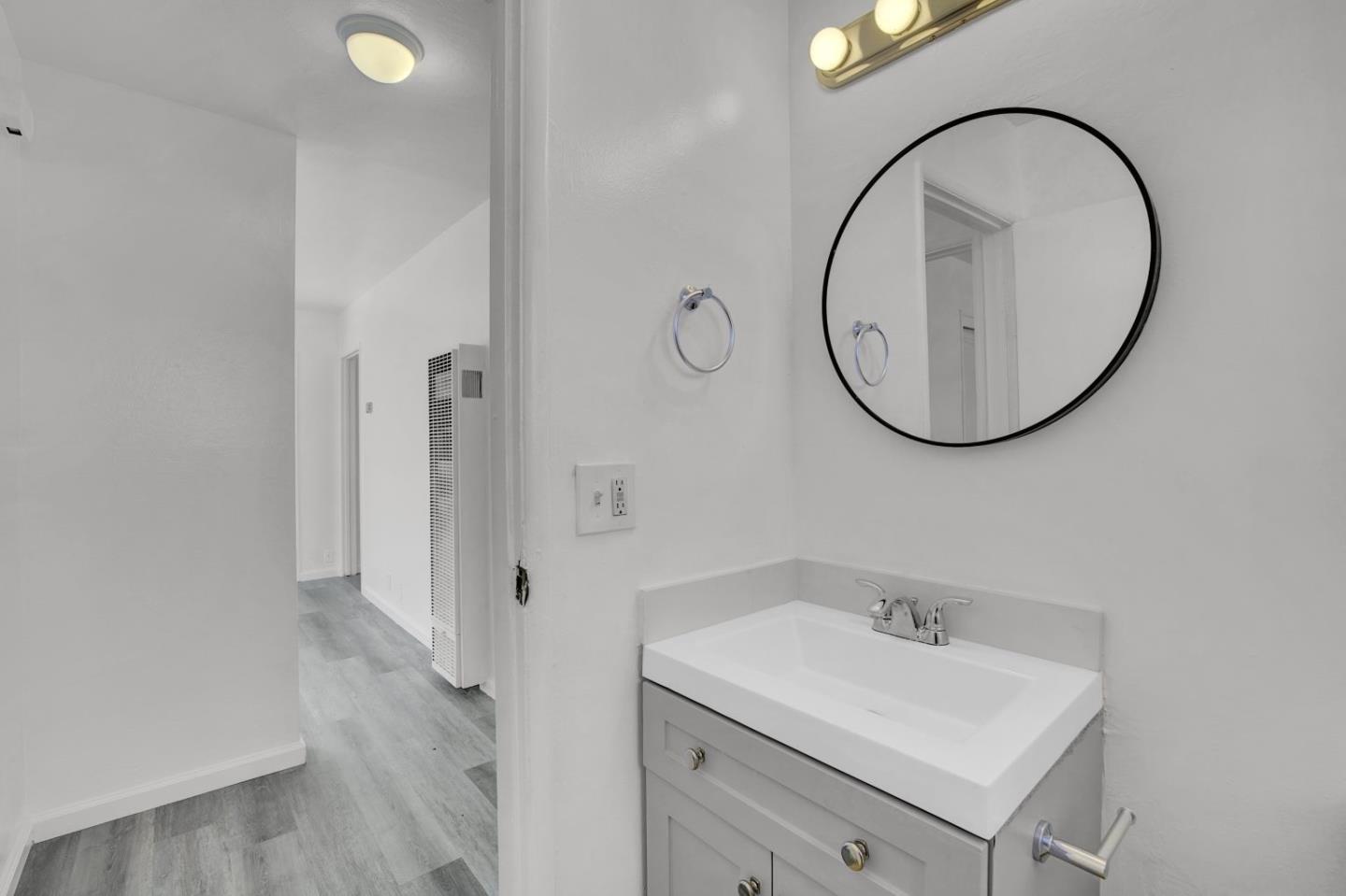 8811 A Street Oakland, CA 94621 - Photo 11 of 30 a bathroom with a sink and a mirror