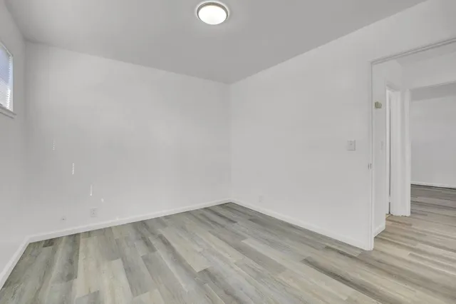 a view of a room with wooden floor