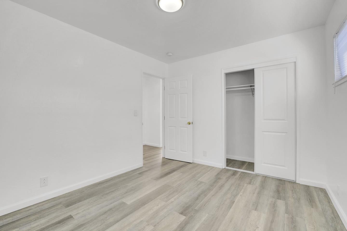 8811 A Street Oakland, CA 94621 - Photo 15 of 30 a view of an empty room with wooden floor