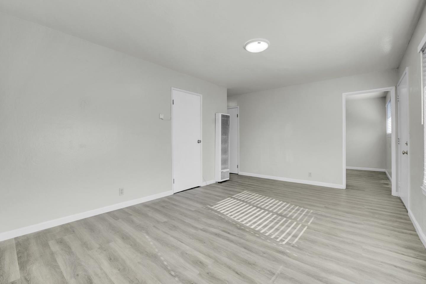 8811 A Street Oakland, CA 94621 - Photo 25 of 30 a view of an empty room and wooden floor