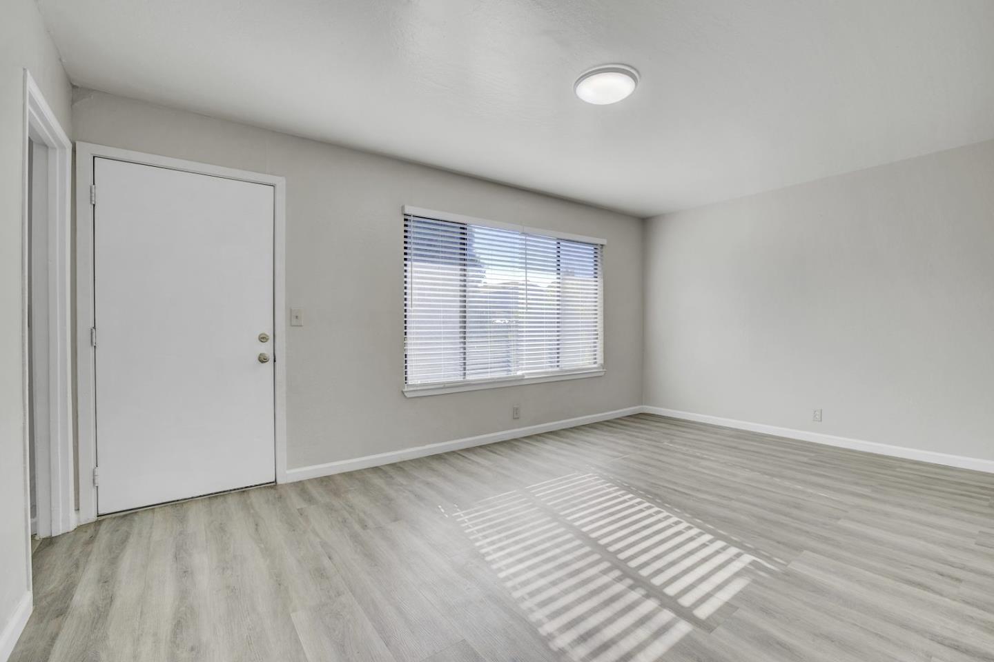 8811 A Street Oakland, CA 94621 - Photo 26 of 30 wooden floor in an empty room with a window