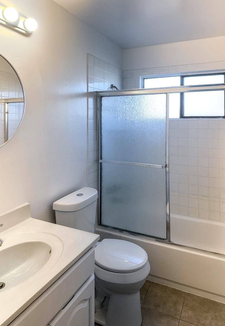 8811 A Street Oakland, CA 94621 - Photo 10 of 30 a bathroom with a sink a toilet and shower