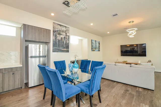 a view of a dining room with furniture and wooden floor