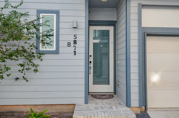 a view of front door and potted plants