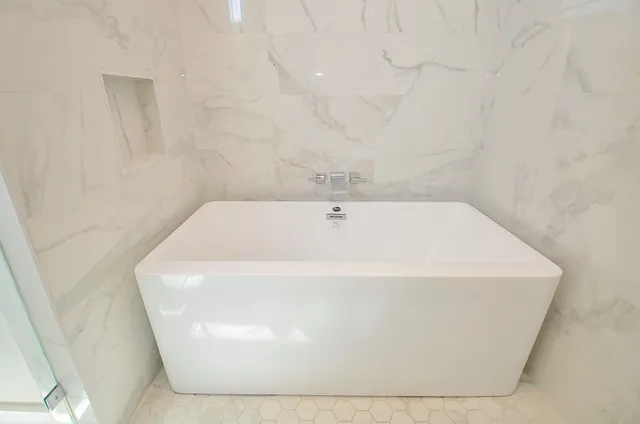 a white bath tub sitting in a bathroom