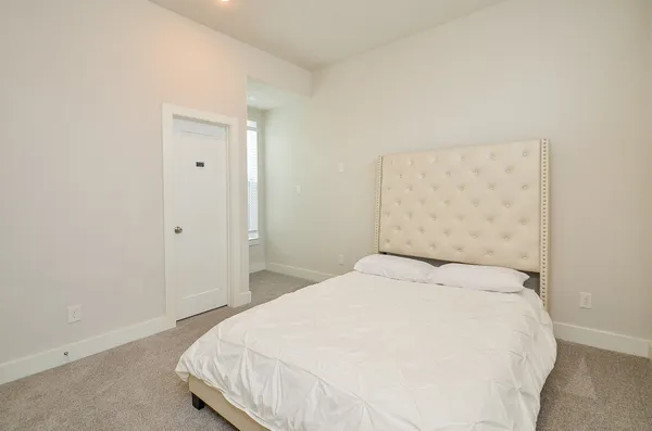 a large white bed in a white room