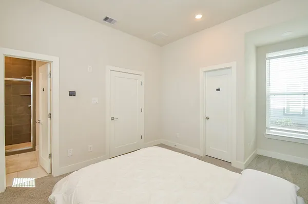 a bedroom with a bed and a window
