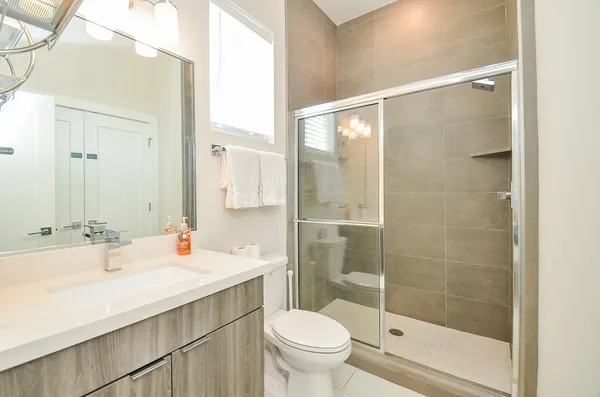 a bathroom with a sink toilet and shower