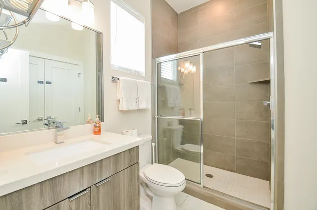 a bathroom with a sink toilet and shower