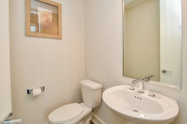 a bathroom with a sink a toilet and mirror