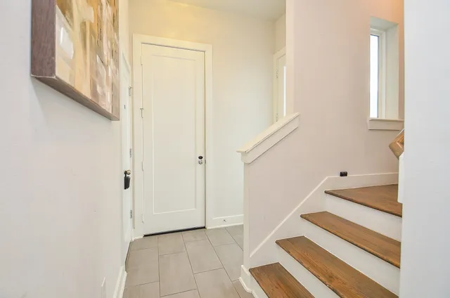 a view of staircase with white walls and a window