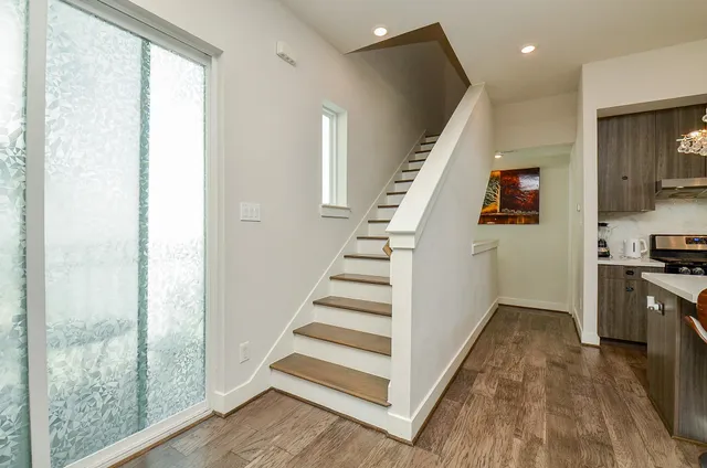 a view of a kitchen with wooden floor and electronic appliances