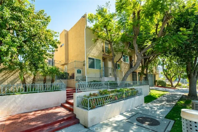 a view of a street with large trees