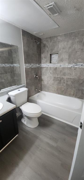 18333 Roehampton Drive, Unit 927 Dallas, TX 75252 - Photo 18 of 26 Bathroom featuring tile walls, vanity, and shower / bathtub combination