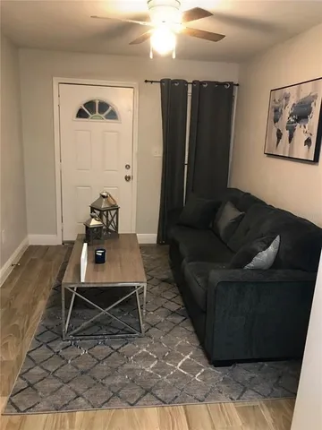 a living room with furniture and a rug