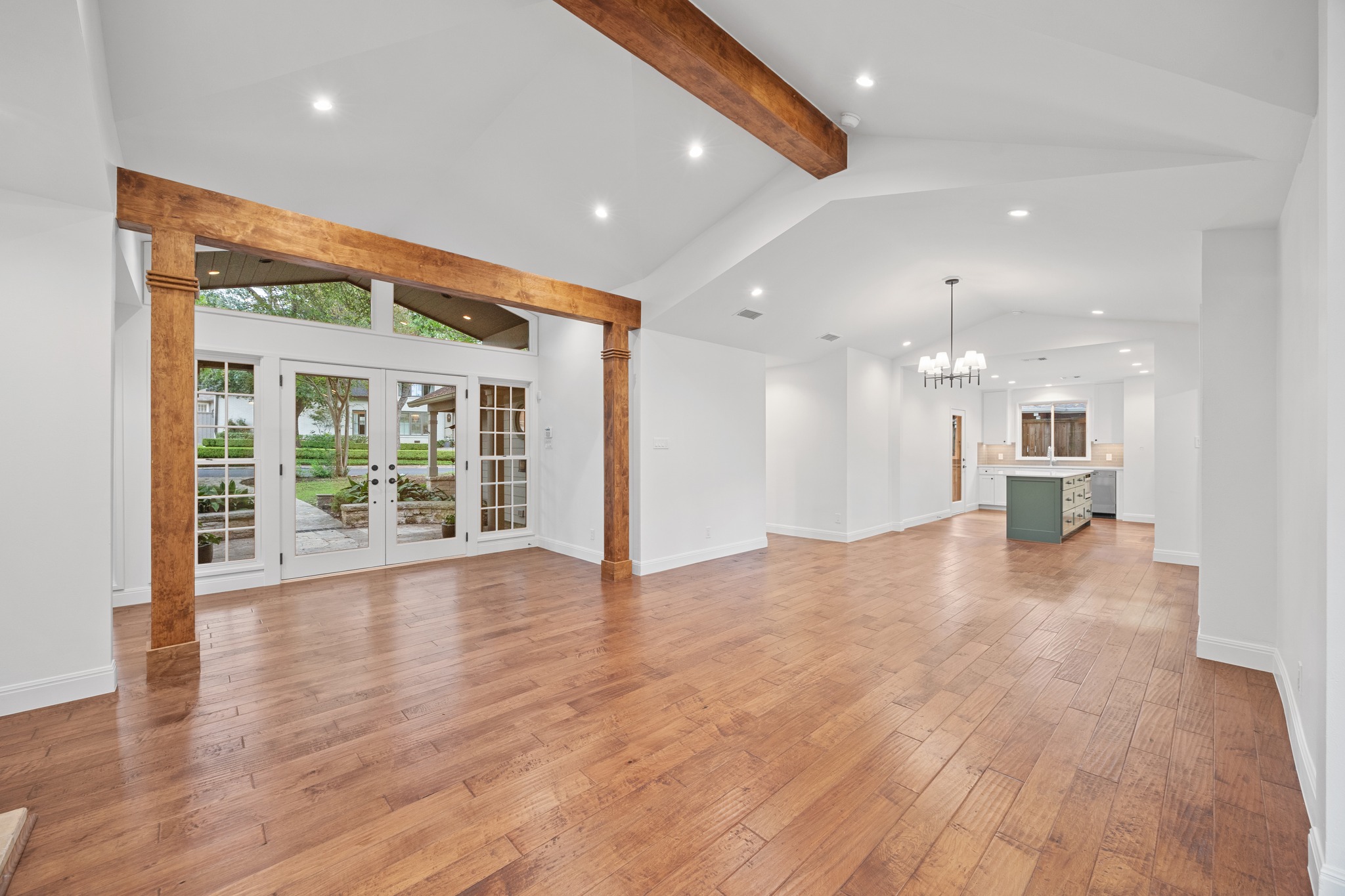 3205 Gilbert Street Austin, TX 78703 - Photo 18 of 35 Expansive open-concept room featuring wide plank wood-finish flooring, vaulted ceilings with exposed wood beams, and recessed lighting