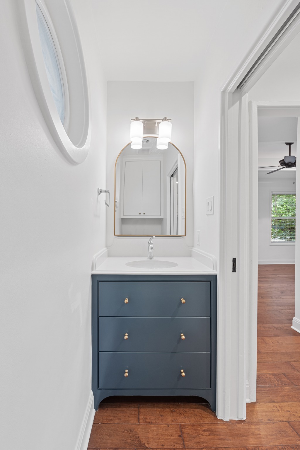 3205 Gilbert Street Austin, TX 78703 - Photo 23 of 35 Vanity featuring a dark blue finish, gold-tone hardware, and a white countertop with an integrated sink