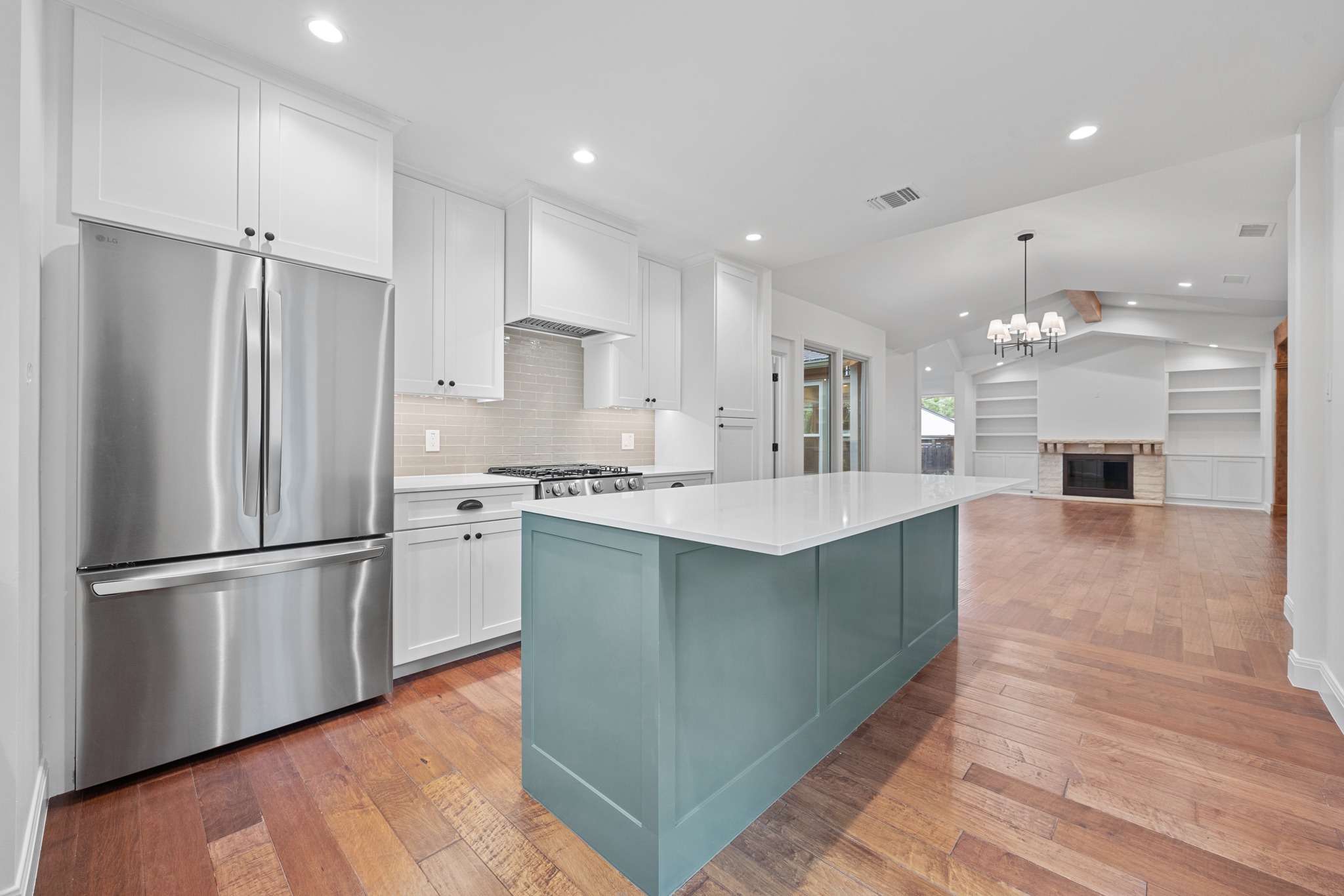 3205 Gilbert Street Austin, TX 78703 - Photo 9 of 35 Modern kitchen featuring a central island with a light teal base and a white countertop