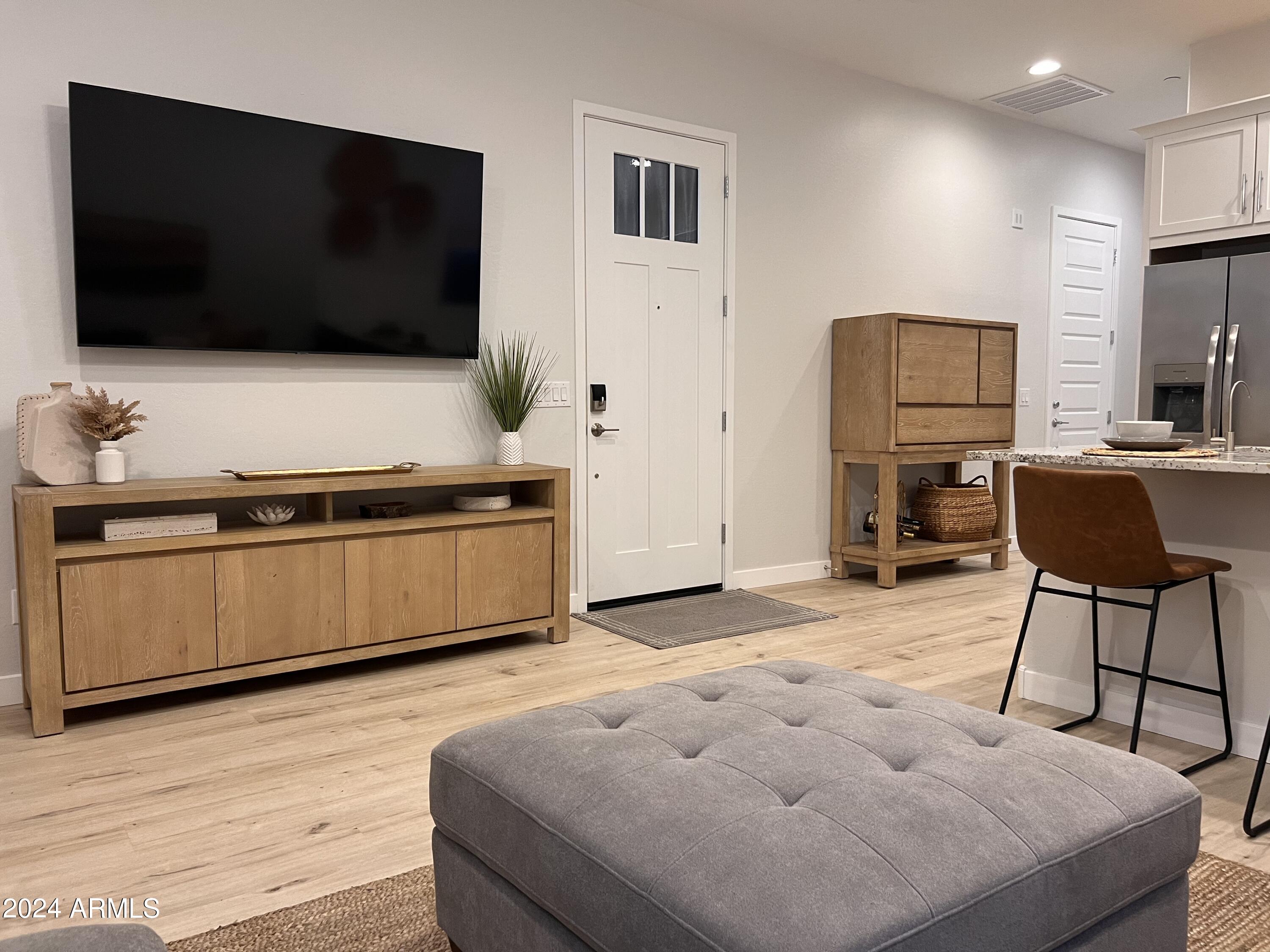 9749 East Tahoe Avenue, Unit 2 Mesa, AZ 85212 - Photo 12 of 25 a living room with furniture and a flat screen tv