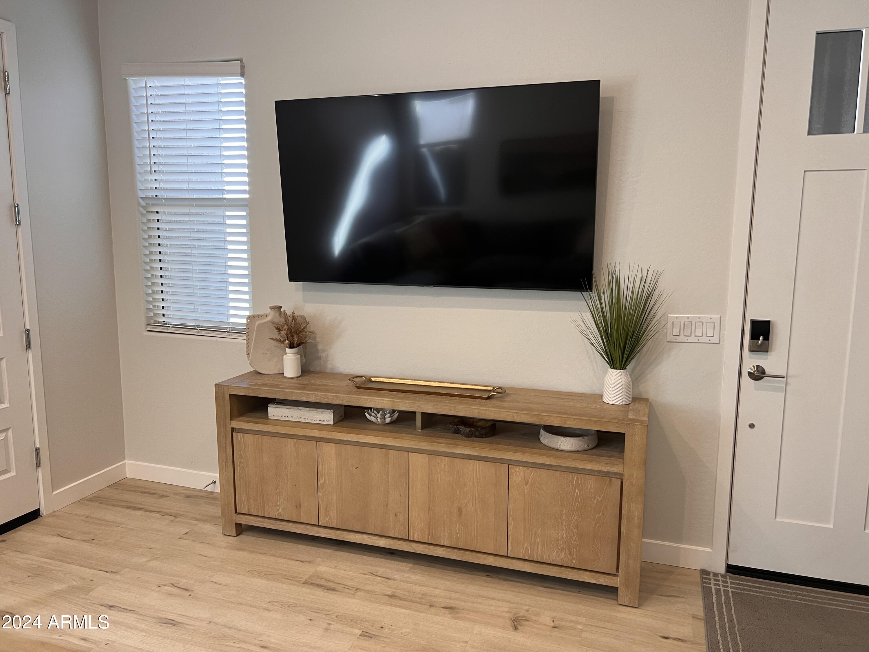 9749 East Tahoe Avenue, Unit 2 Mesa, AZ 85212 - Photo 2 of 25 a living room with furniture and a flat screen tv