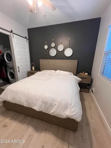 a large bed sitting in a bedroom next to a window and a lamp