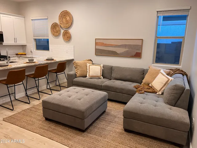 a living room with furniture and a large window