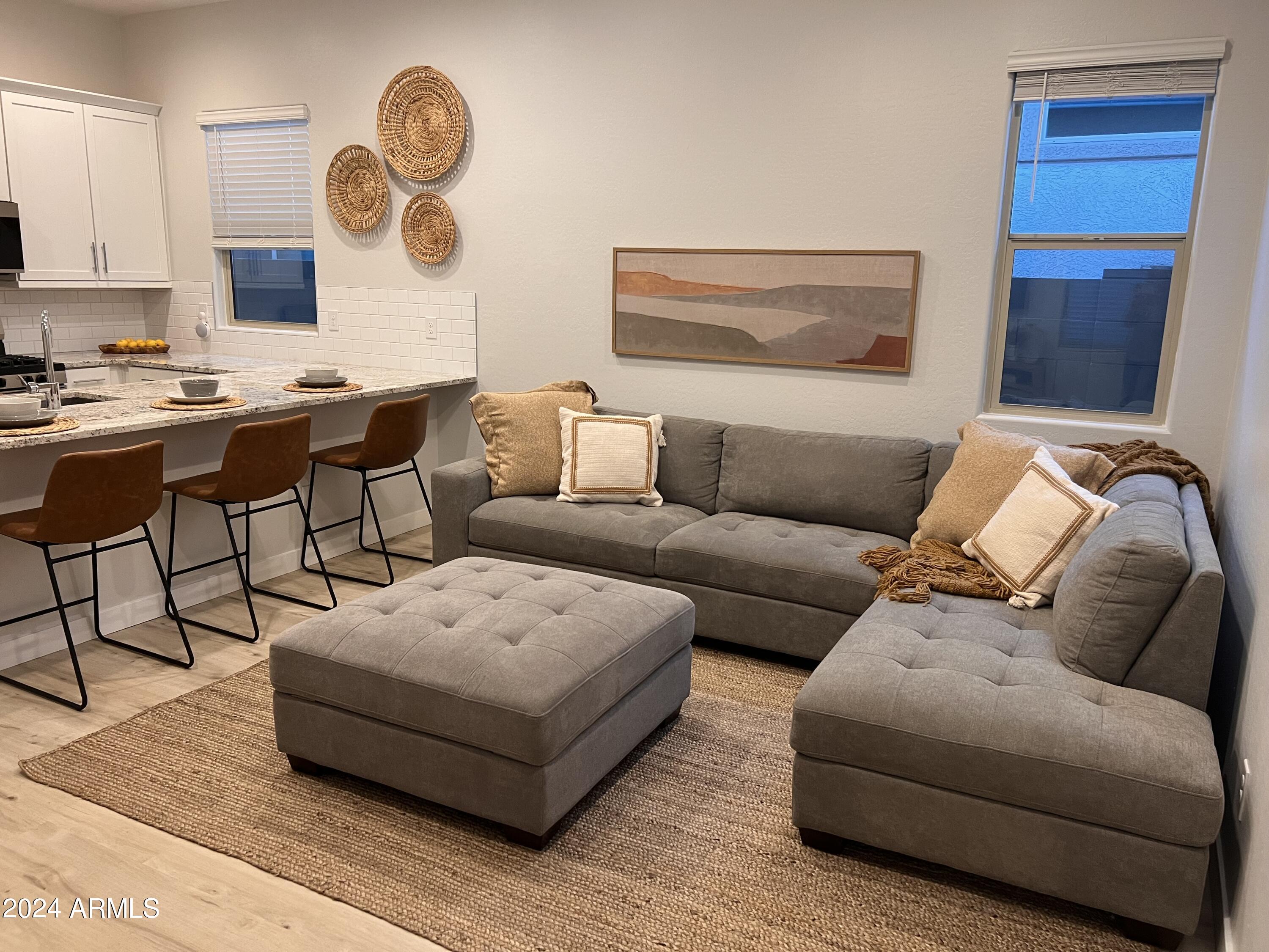 9749 East Tahoe Avenue, Unit 2 Mesa, AZ 85212 - Photo 7 of 25 a living room with furniture and a large window