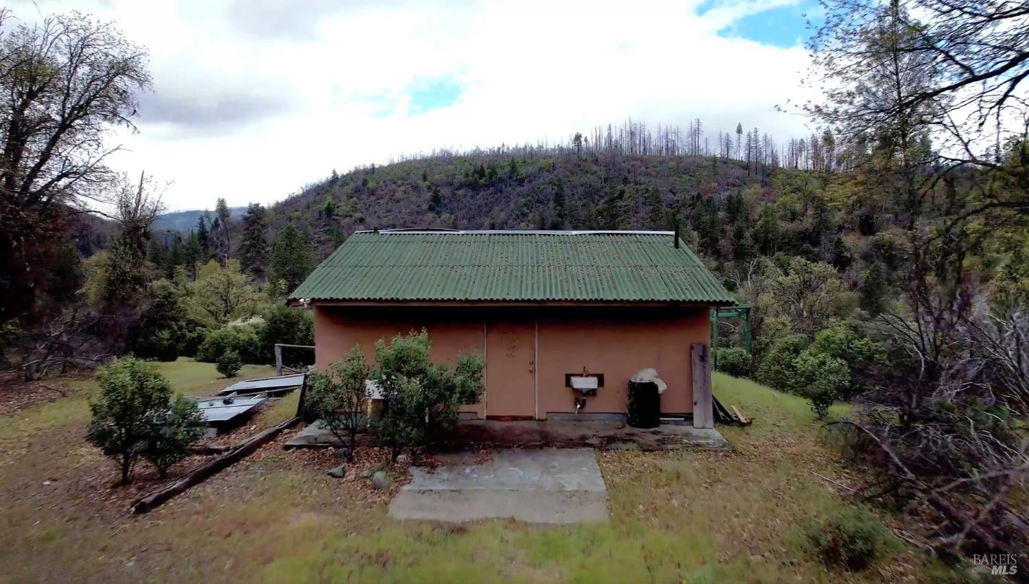 2168 Bear Creek Road Upper Lake, CA 95485 - Photo 5 of 16 a view of a house with a backyard and sitting area