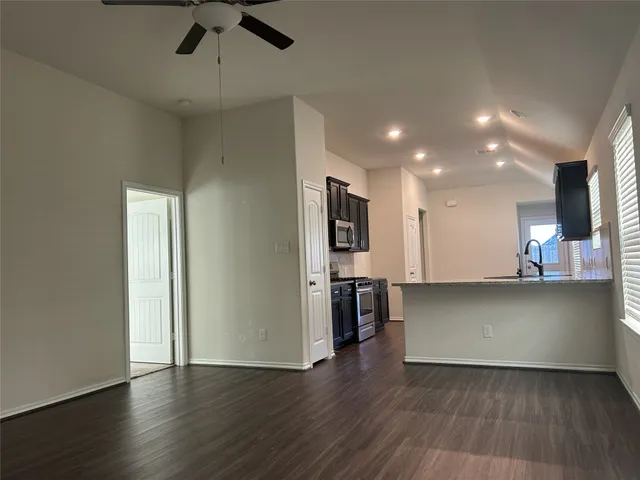 a view of a kitchen with a sink and a refrigerator