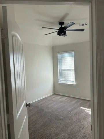 a view of an empty room with a window