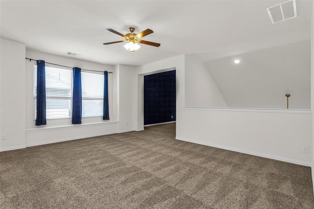 15713 Canyon Ridge Prosper, TX 75078 - Photo 34 of 38 Spacious carpeted room featuring multiple windows with blinds and curtain rods, a ceiling fan with integrated lighting, a recessed ceiling light, and a white interior wall with a half-wall partition
