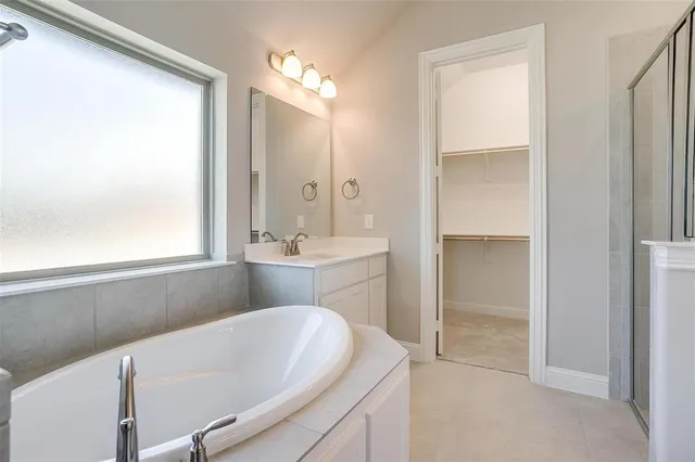 a bathroom with a bathtub and a sink