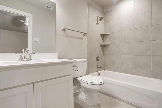 en empty room with a ceiling fan and window