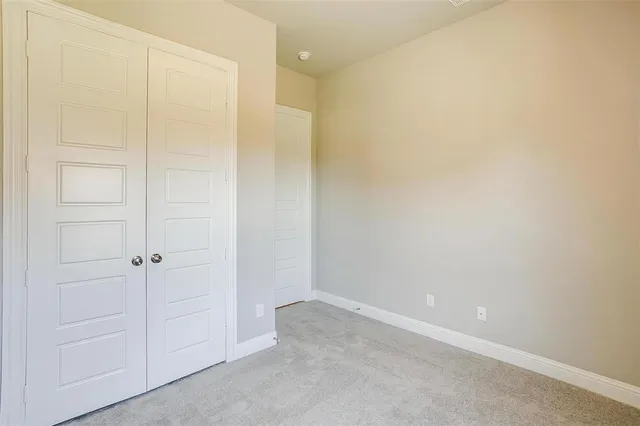 an empty room with fan and entrance