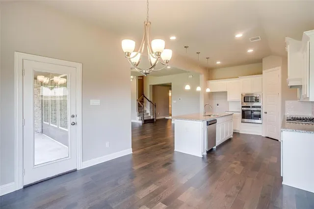 a view of a kitchen and windows