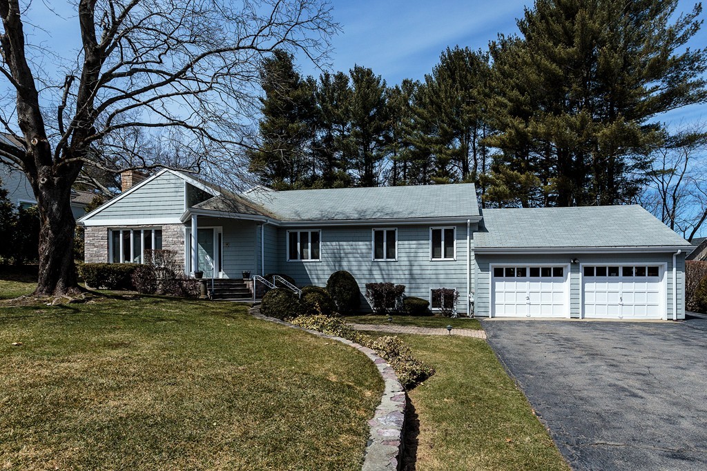 11 Woodfall Road Belmont, MA 02478 - Photo 1 of 26 a front view of a house with a yard table and chairs