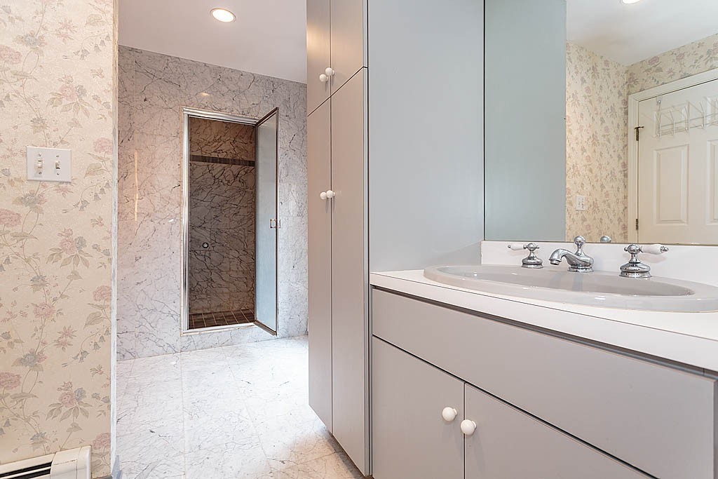 11 Woodfall Road Belmont, MA 02478 - Photo 12 of 26 a bathroom with a sink and a mirror