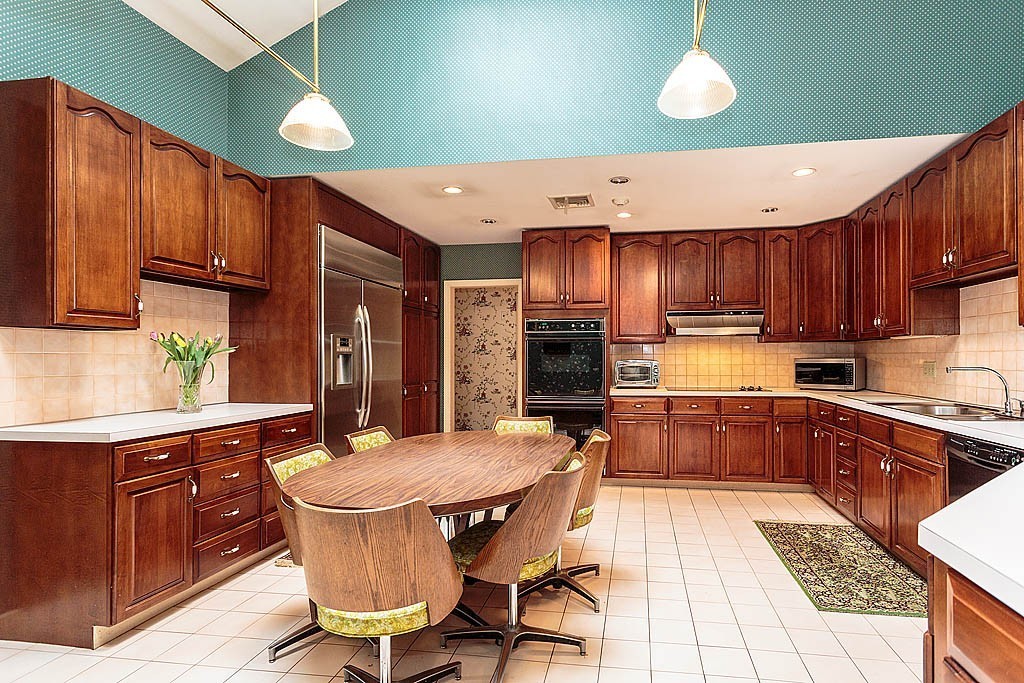 11 Woodfall Road Belmont, MA 02478 - Photo 19 of 26 a kitchen with a table chairs sink and cabinets