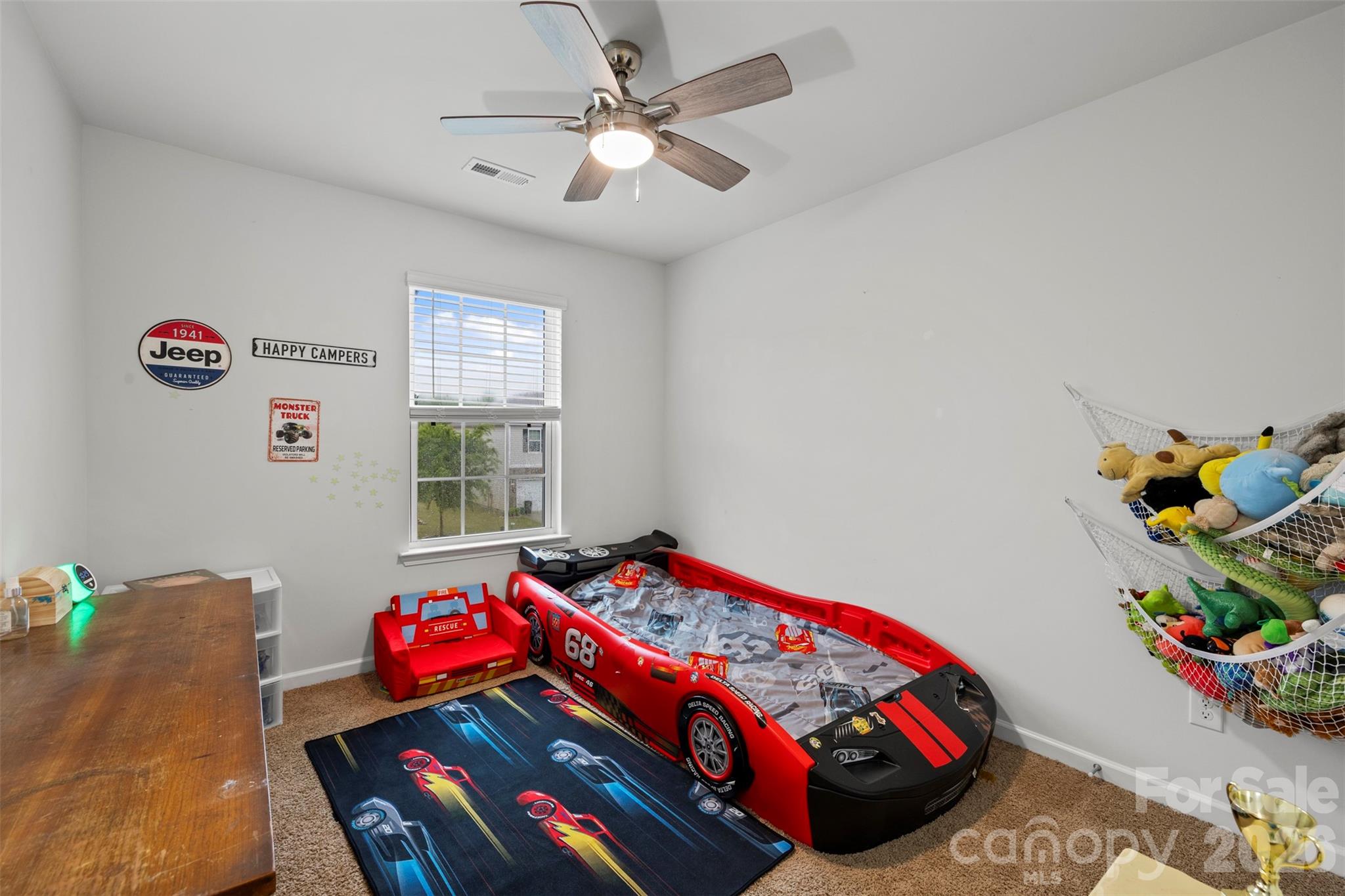 225 Final Stretch Lane Clover, SC 29710 - Photo 27 of 39 a bedroom with a bed and a chandelier