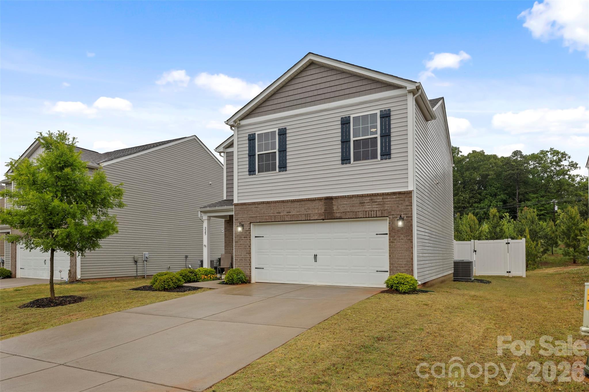 225 Final Stretch Lane Clover, SC 29710 - Photo 10 of 39 a front view of a house with a yard and garage