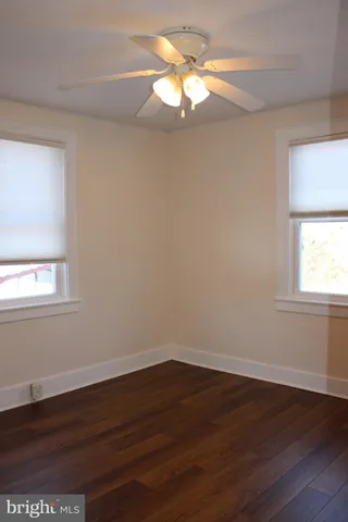 a view of a room with wooden floor and a window