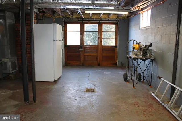 a room with table chairs and wooden floor
