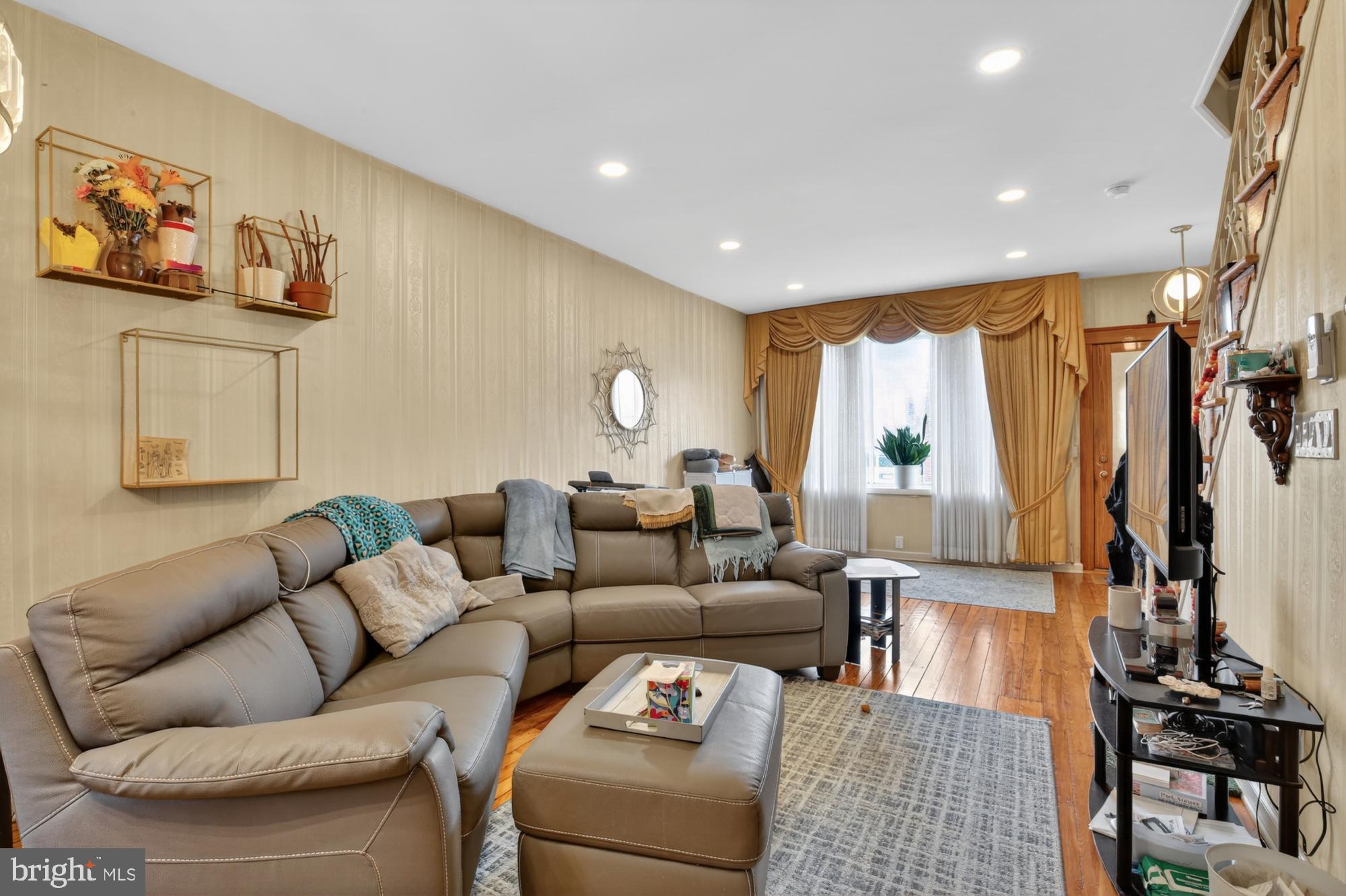 3147 Edgemont Street Philadelphia, PA 19134 - Photo 1 of 23 a living room with furniture and a large window