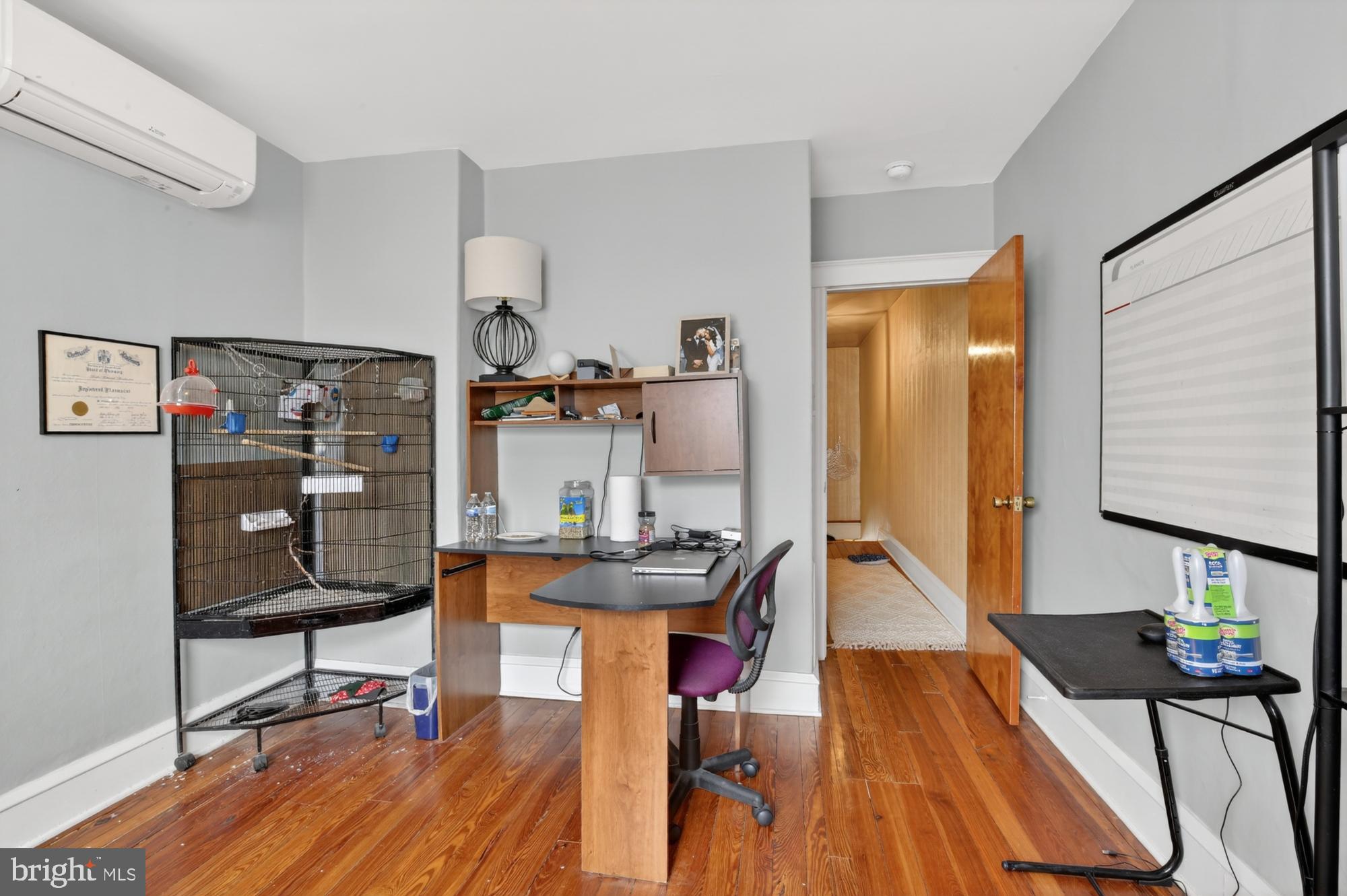3147 Edgemont Street Philadelphia, PA 19134 - Photo 15 of 23 a view of a workspace with furniture and wooden floor