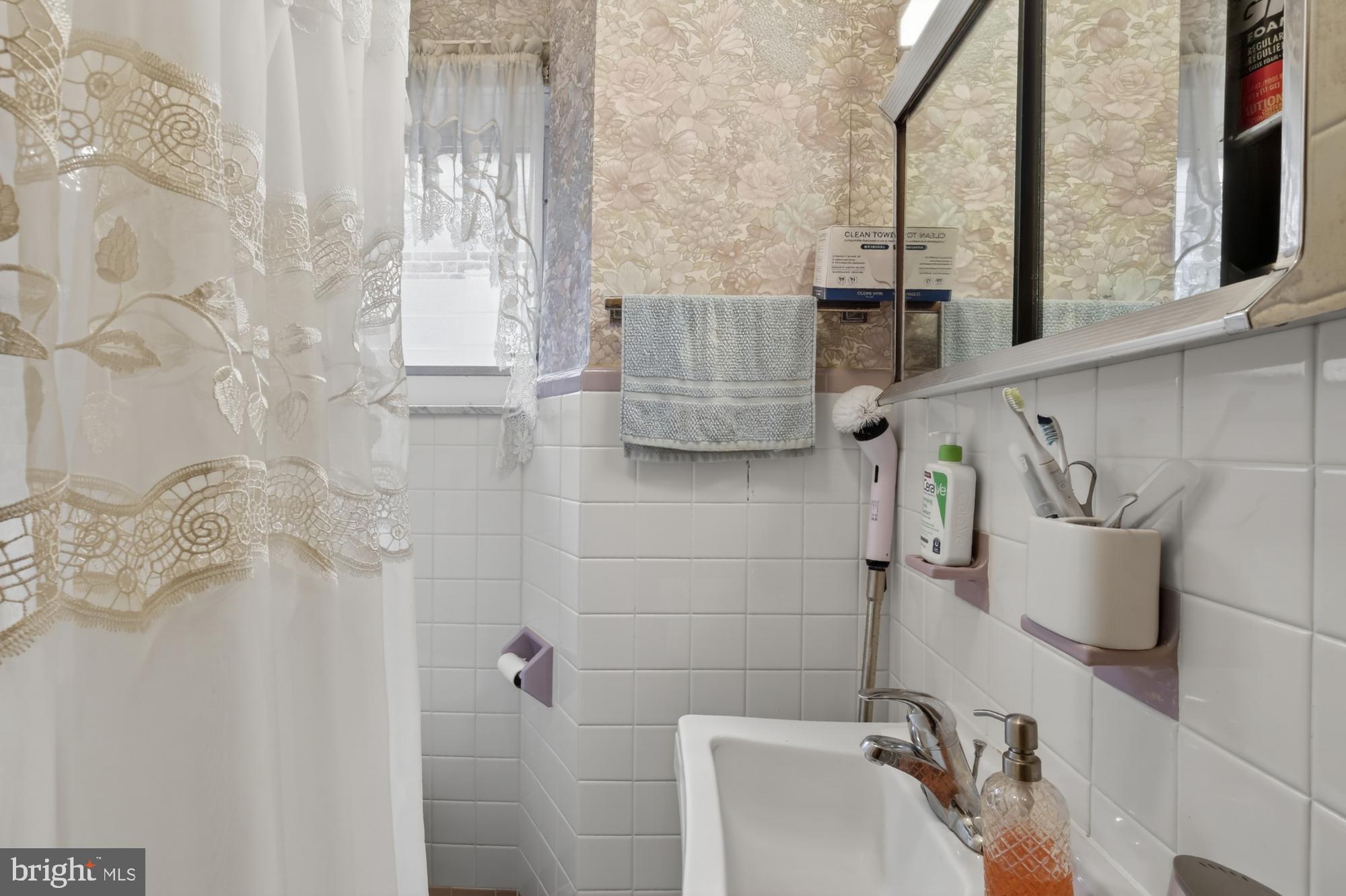 3147 Edgemont Street Philadelphia, PA 19134 - Photo 16 of 23 a bathroom with a sink and mirror
