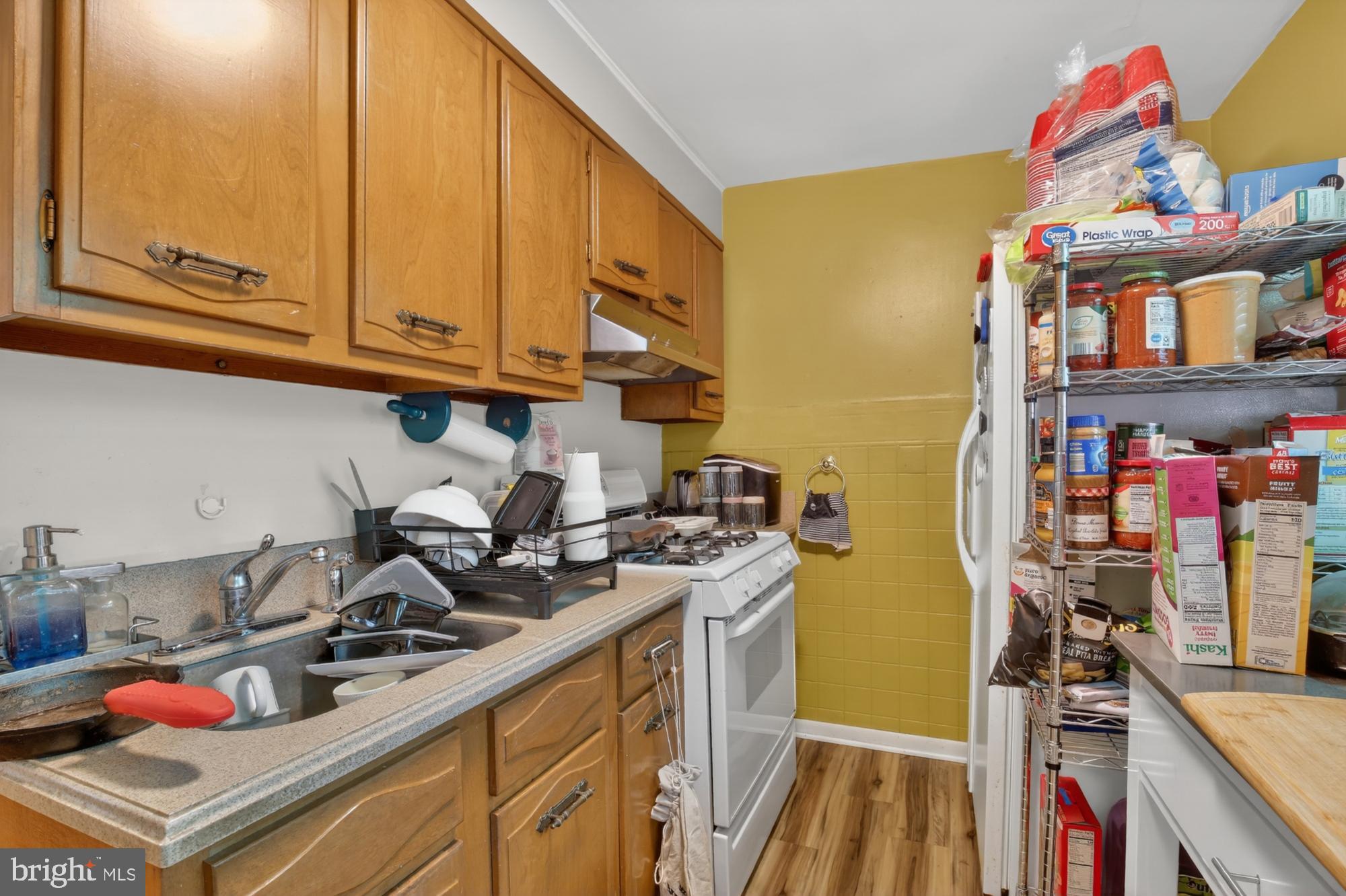 3147 Edgemont Street Philadelphia, PA 19134 - Photo 9 of 23 a kitchen with stainless steel appliances granite countertop a stove and cabinets