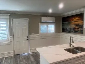 a kitchen with a sink and a hard wood floor
