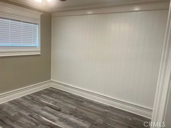 a view of a small space with wooden floor and a window